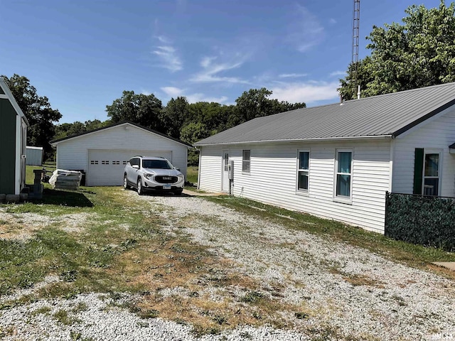 view of side of property featuring an outbuilding and a garage