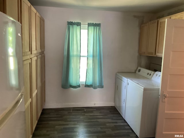 laundry area with separate washer and dryer, dark wood-type flooring, and cabinets