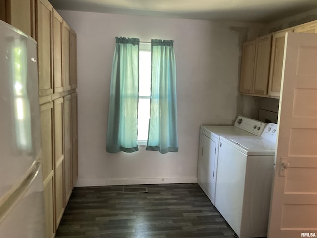 laundry room with cabinets, dark hardwood / wood-style floors, and washing machine and dryer