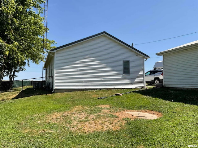 view of side of home featuring a lawn