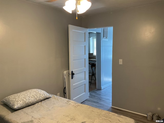 bedroom with wood-type flooring and ceiling fan