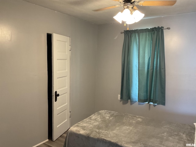 bedroom featuring hardwood / wood-style flooring and ceiling fan