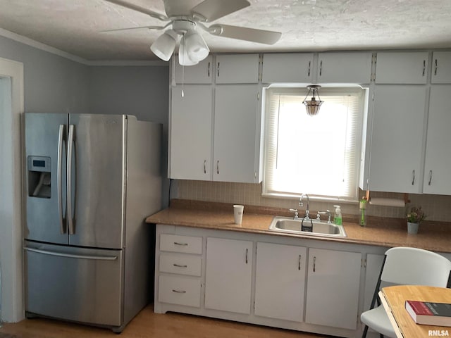 kitchen featuring stainless steel fridge with ice dispenser, ceiling fan, crown molding, hardwood / wood-style floors, and sink