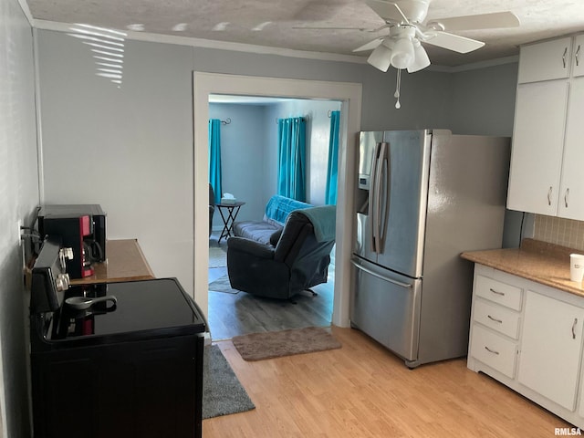 kitchen featuring ceiling fan, crown molding, stainless steel refrigerator with ice dispenser, light wood-type flooring, and white cabinetry