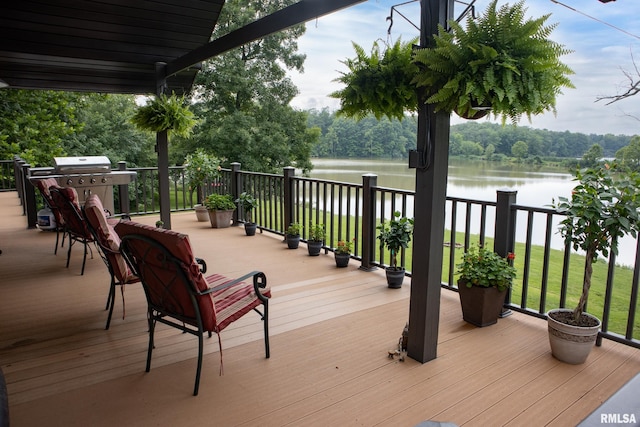 wooden deck with area for grilling and a water view