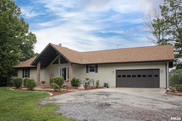 ranch-style house with a garage and a front lawn