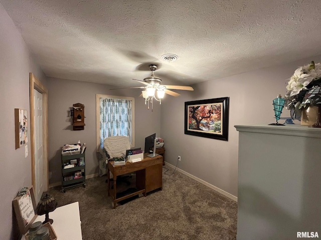 carpeted office space with a textured ceiling and ceiling fan