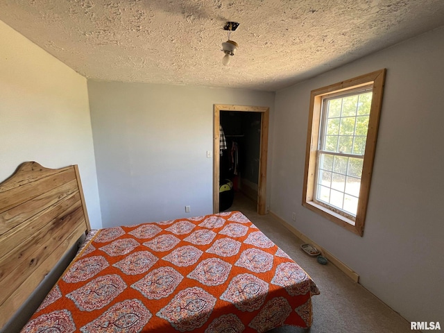 bedroom featuring a textured ceiling and carpet flooring