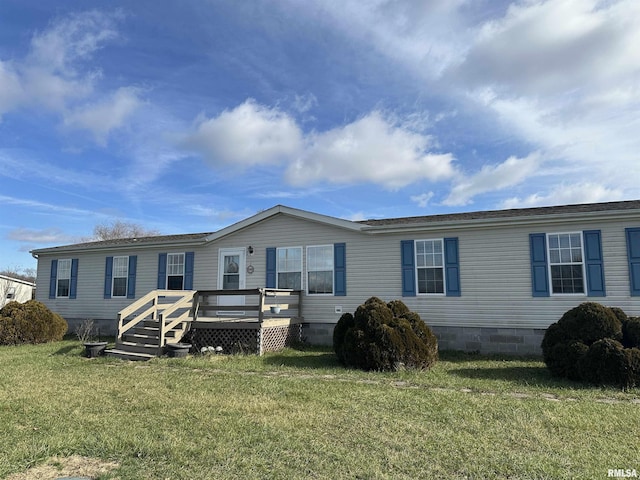 manufactured / mobile home featuring a front lawn and a wooden deck