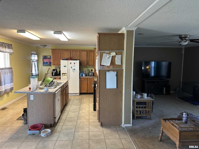 kitchen featuring light tile patterned floors, light countertops, white appliances, and a kitchen island