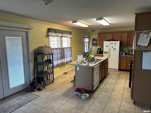 kitchen with ornamental molding, white appliances, and a sink