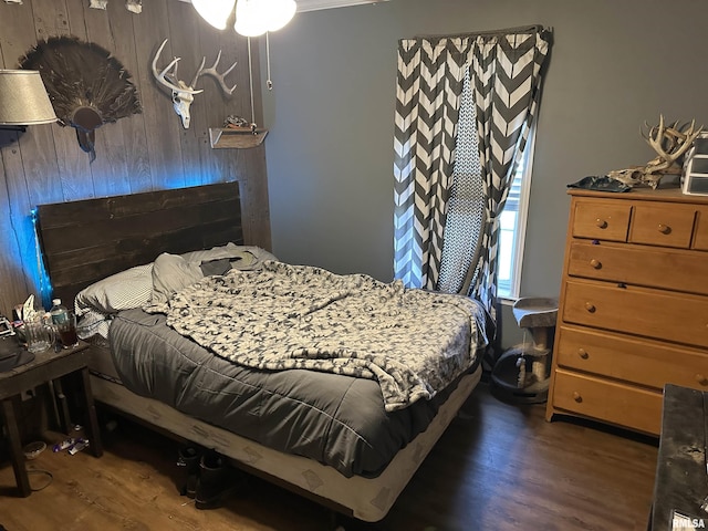 bedroom with dark hardwood / wood-style floors