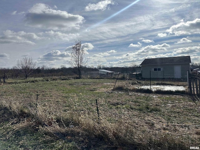 view of yard featuring a rural view and fence