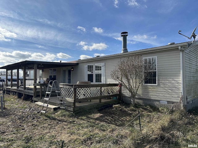 back of property featuring a deck and crawl space