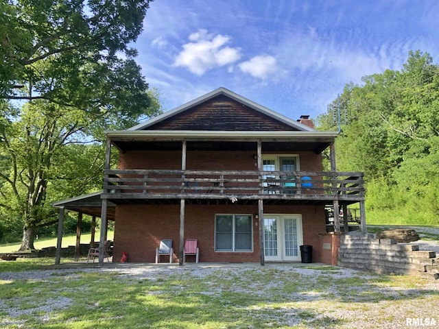 back of house with a yard, french doors, a patio, and a deck