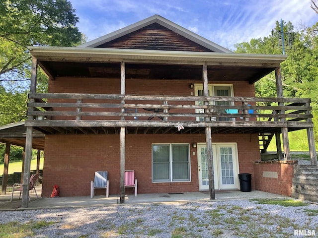 rear view of property with a patio and a wooden deck