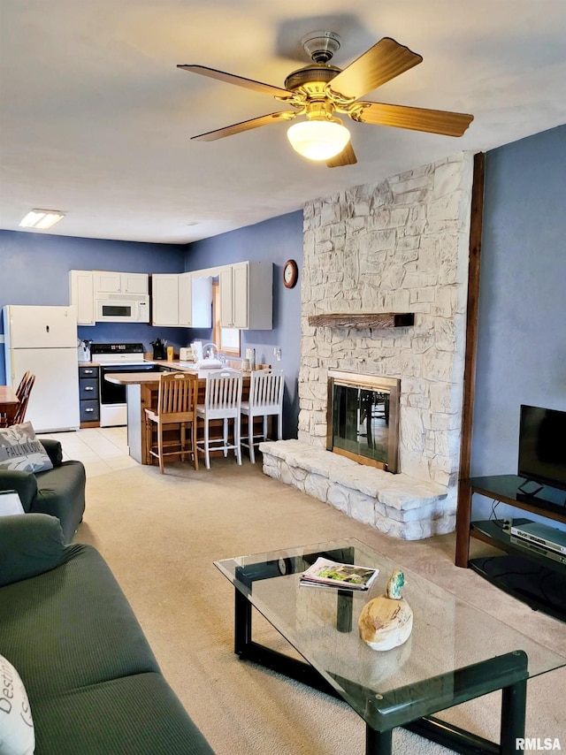 living room with ceiling fan, a fireplace, and light carpet