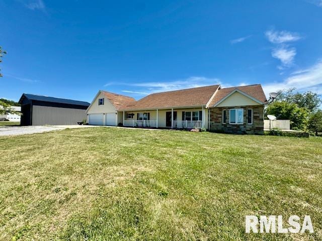 view of front of property with a garage and a front lawn