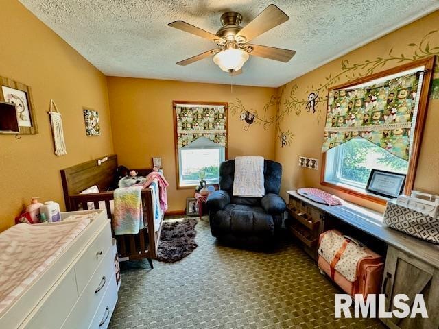 interior space with a textured ceiling and ceiling fan