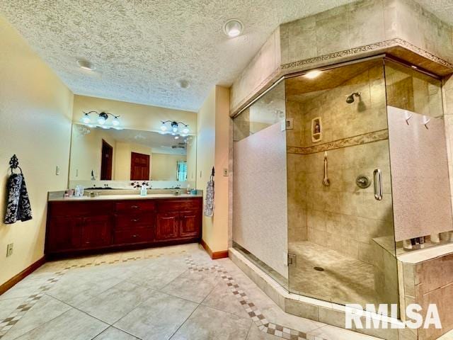 bathroom featuring tile patterned flooring, a textured ceiling, double sink vanity, and an enclosed shower