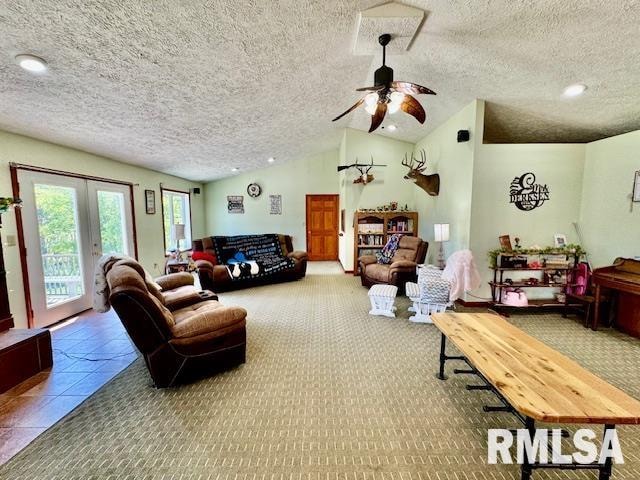 living room featuring a textured ceiling, carpet flooring, lofted ceiling, and ceiling fan