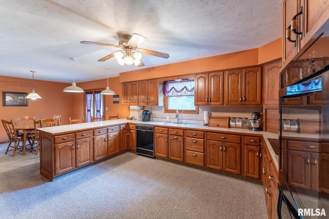 kitchen featuring kitchen peninsula, pendant lighting, light colored carpet, a textured ceiling, and black appliances