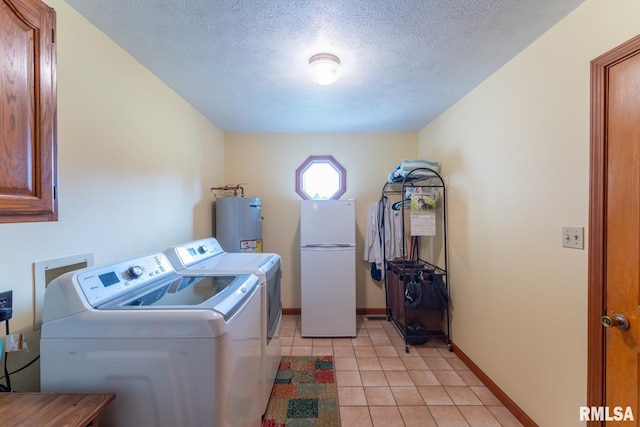 laundry area with cabinets, water heater, a textured ceiling, light tile patterned floors, and washer and dryer