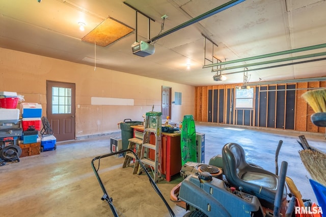 garage with electric panel and a garage door opener