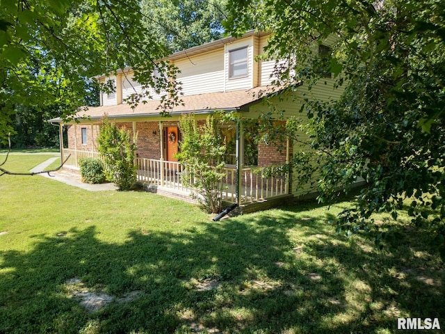 view of front facade with covered porch and a front yard