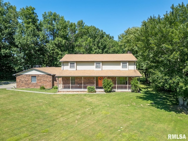 view of front of house with covered porch and a front lawn