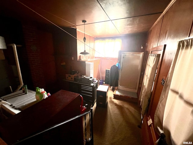 interior space with carpet floors and brick wall