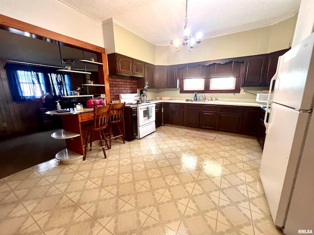 kitchen featuring white appliances, light countertops, dark brown cabinets, light floors, and a notable chandelier