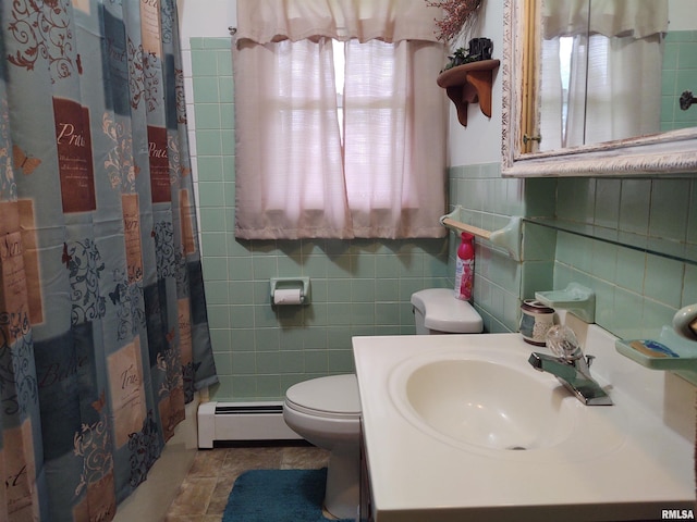 bathroom with tile walls, a baseboard radiator, walk in shower, vanity, and toilet