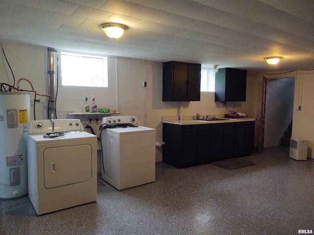 laundry room featuring washer and clothes dryer, cabinets, water heater, and a healthy amount of sunlight