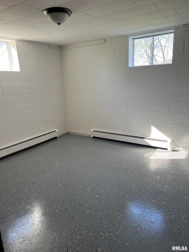 basement featuring baseboard heating and plenty of natural light