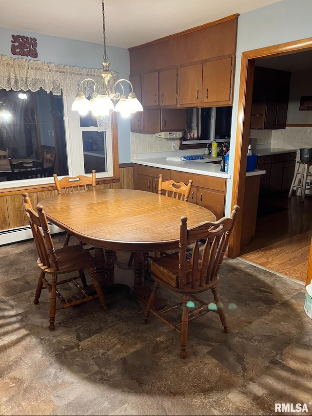 dining space featuring wood-type flooring and an inviting chandelier