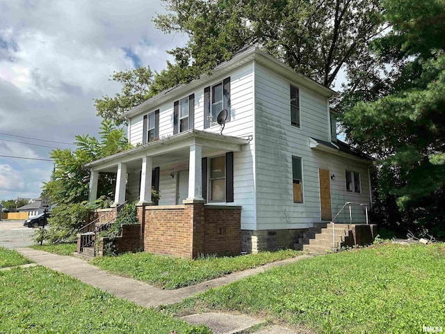 view of front of home with a porch and a front yard