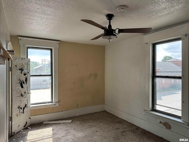 spare room with a textured ceiling and ceiling fan