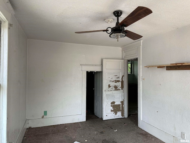 unfurnished bedroom with a textured ceiling and ceiling fan