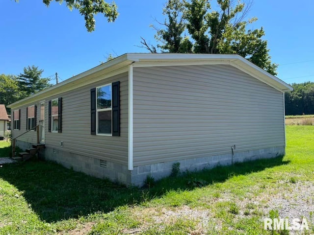 view of side of home with a lawn