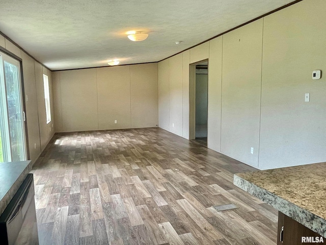 spare room with hardwood / wood-style flooring and a textured ceiling