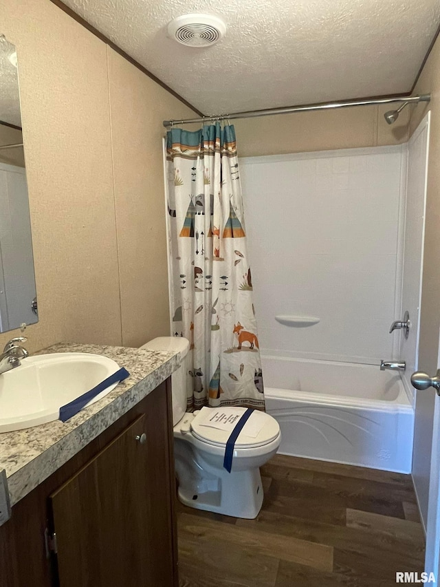 full bathroom featuring shower / tub combo with curtain, vanity, a textured ceiling, and hardwood / wood-style flooring