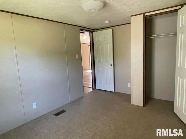 unfurnished bedroom with carpet and a textured ceiling