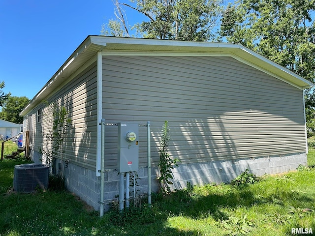 view of side of home with central AC