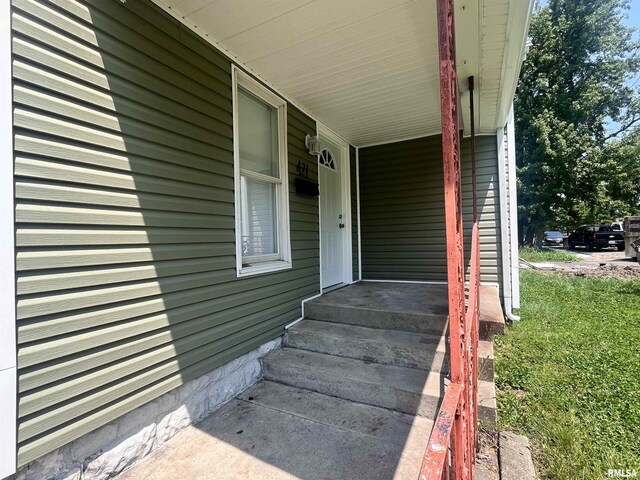 view of exterior entry with covered porch