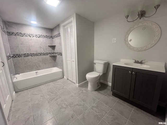 full bathroom featuring toilet, vanity, tiled shower / bath, and tile patterned flooring