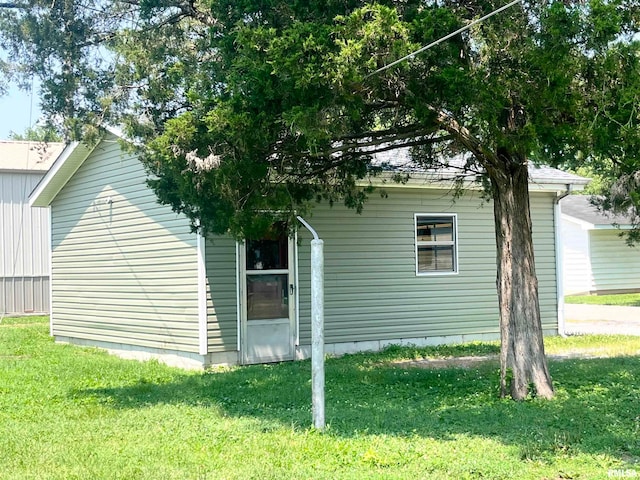 view of side of property with a yard