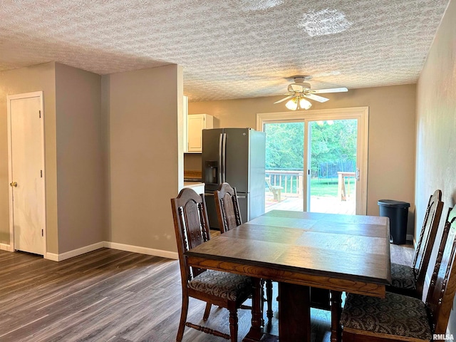 dining room featuring a textured ceiling, dark wood-type flooring, and ceiling fan