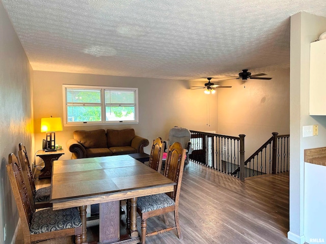 dining room with a textured ceiling, ceiling fan, and hardwood / wood-style flooring