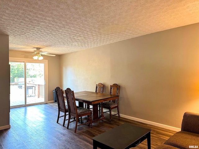 dining room with a textured ceiling, dark hardwood / wood-style flooring, and ceiling fan